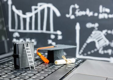 ladder-grad-cap-diploma-on-keyboard-graph-background