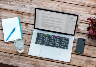 laptop-glass-phone-on-wood-table