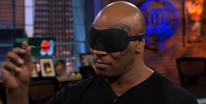 Mike Tyson shooting darts blindfolded