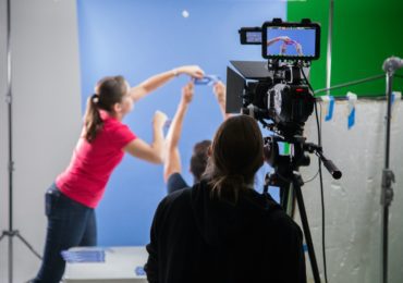woman holding black video camera