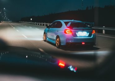blue car driving on dark road