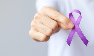 hand-holding-purple-ribbon