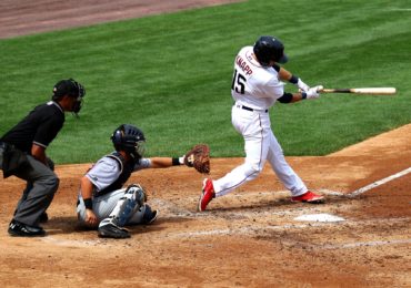 Baseball player swinging and missing pitch