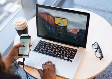 Person on phone and laptop