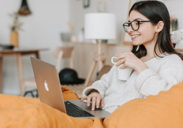 woman having coffee while using laptop