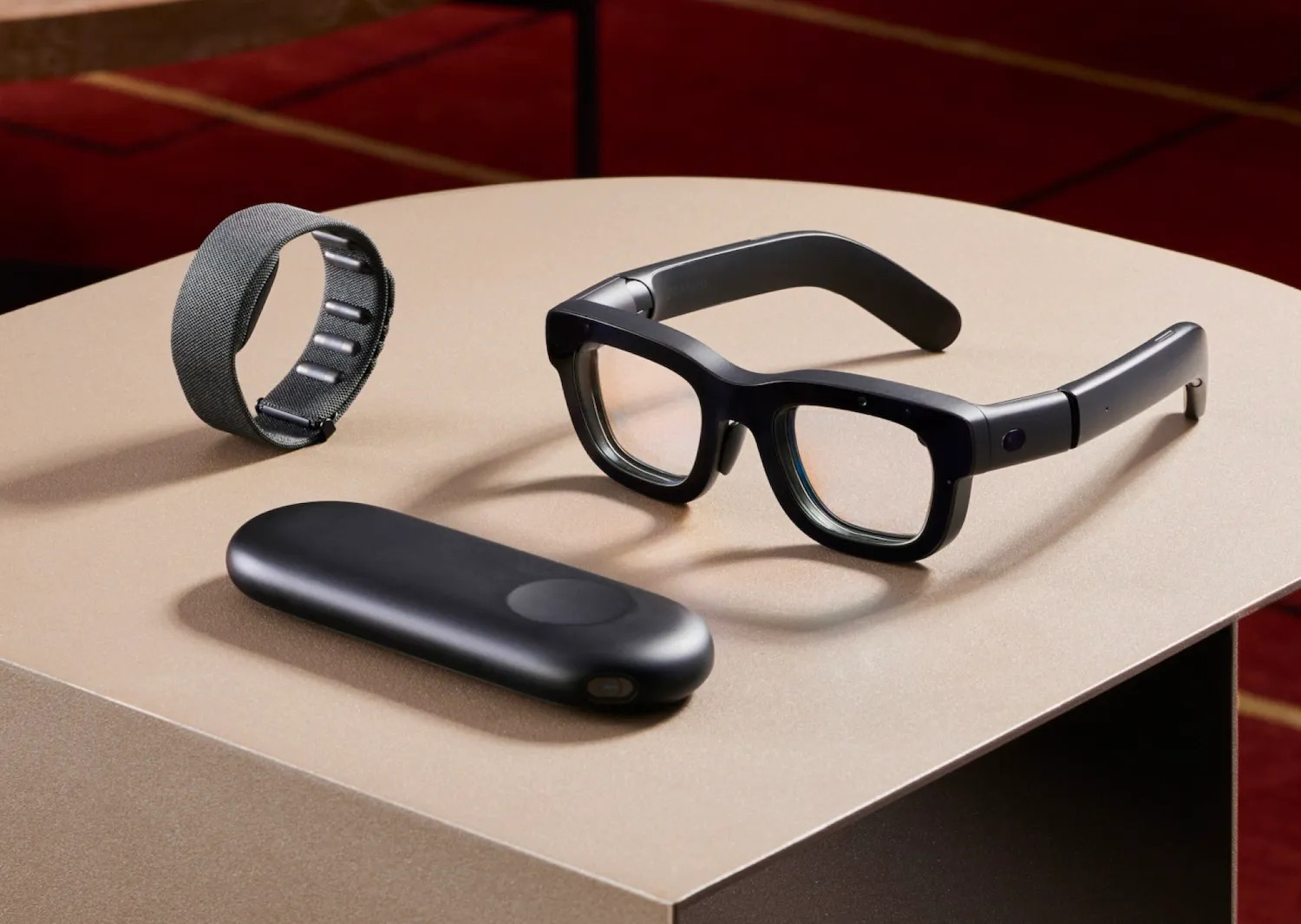 a VR glass, a smart band and a meta controller on brown surface with brown background