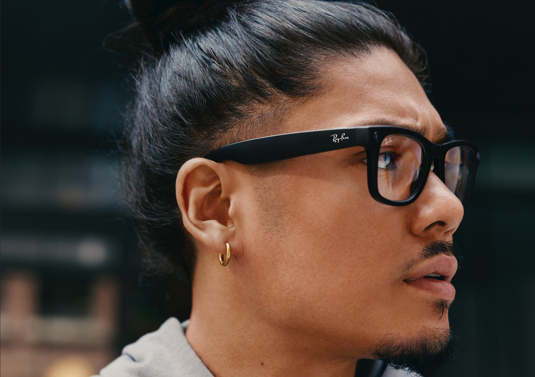 A guy wearing a meta ray ban smart glass staring right side